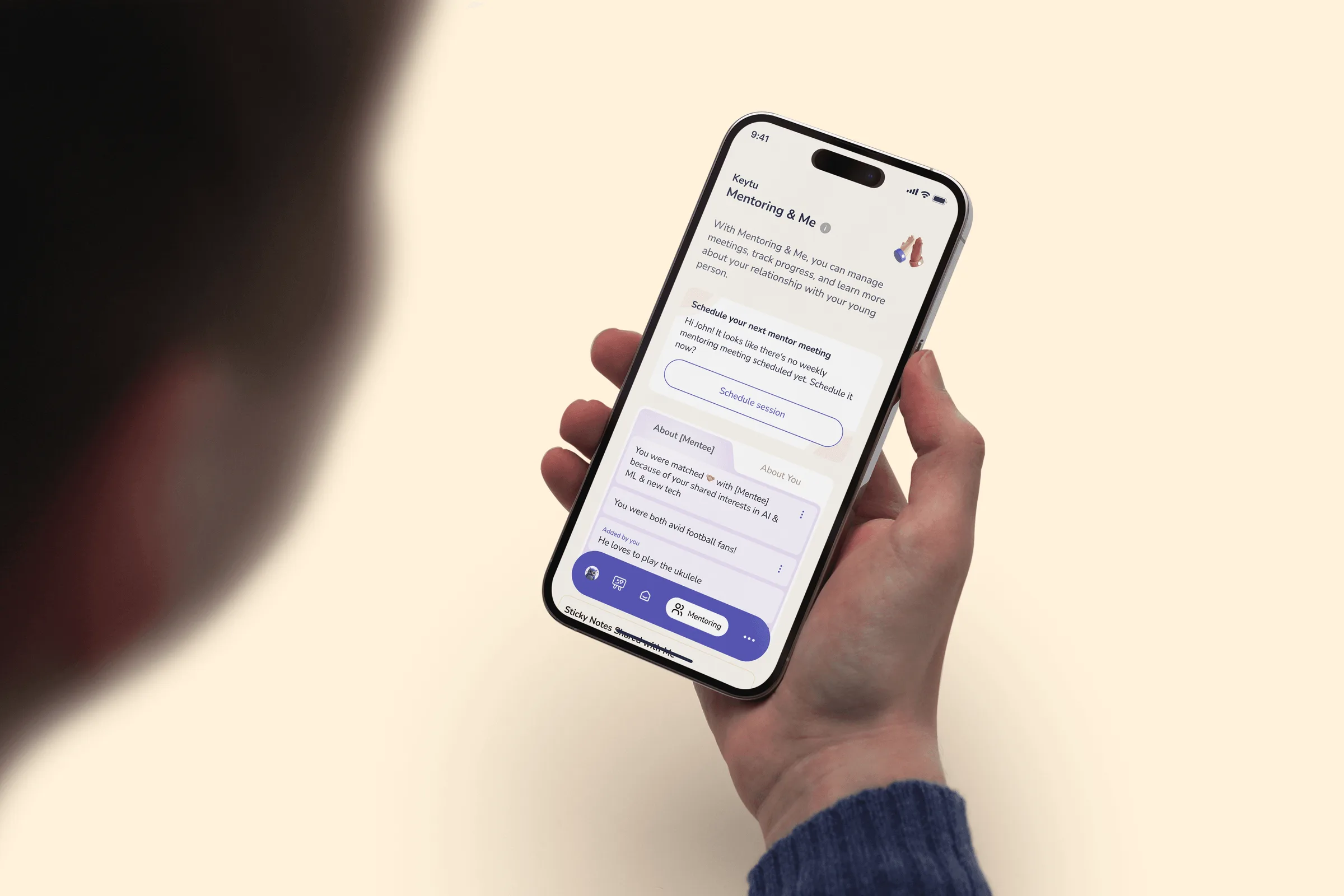 Hand holding a phone showing a KeyTu planning conversation