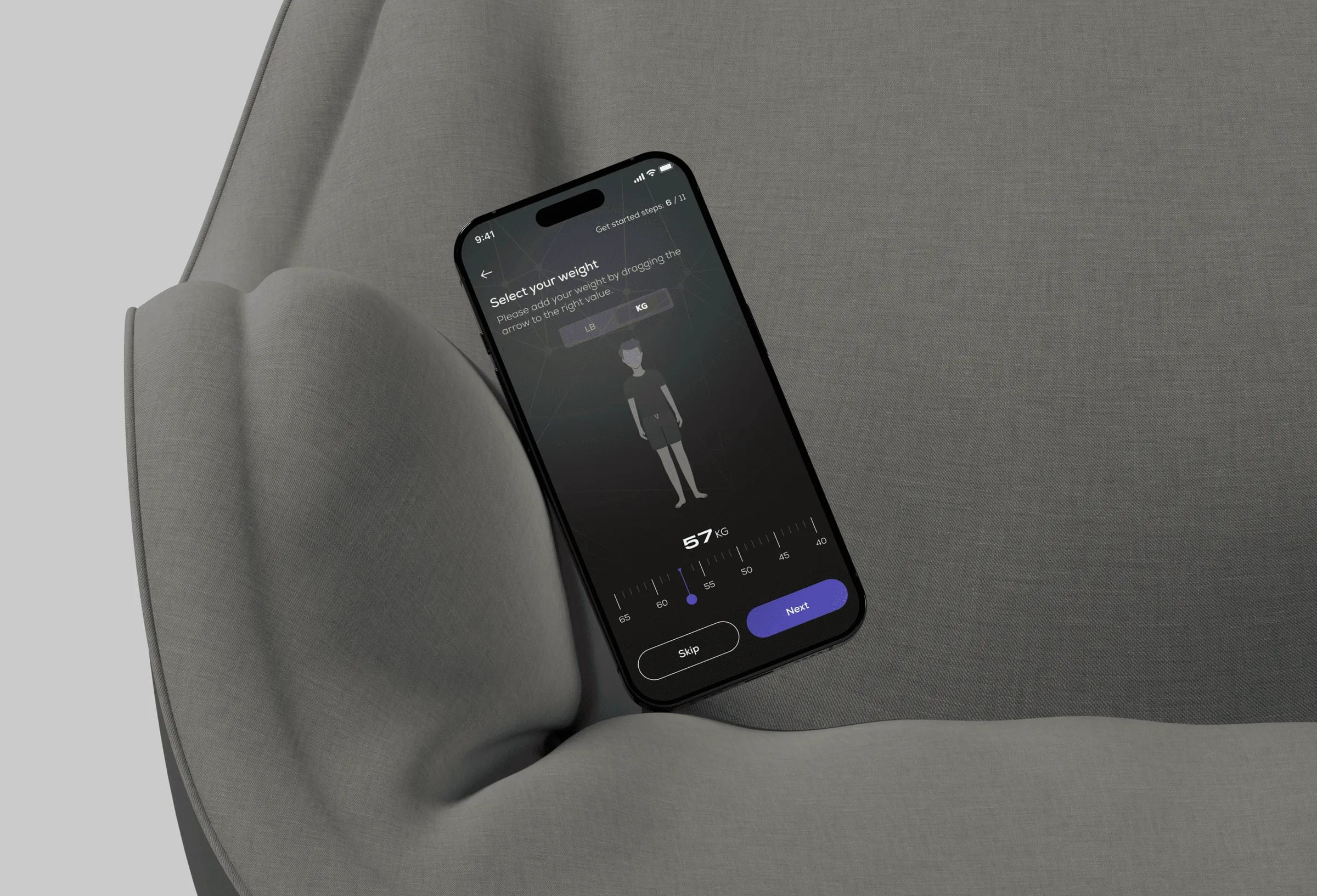 Phone resting on a grey armchair, showing the W3 Sport weight entry screen